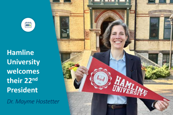 Photo of Dr. Mayme Hostetter holding Hamline flag